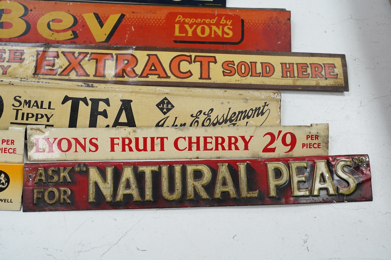 Eleven early / mid 20th century tinplate advertising shelf strips, largest 60cm. Condition - fair